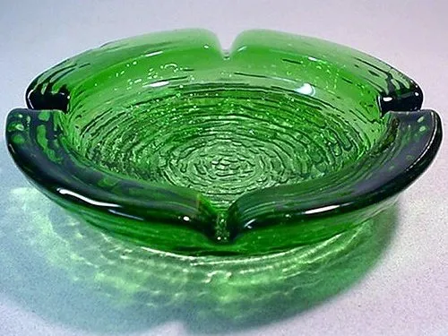 A round green glass ashtray