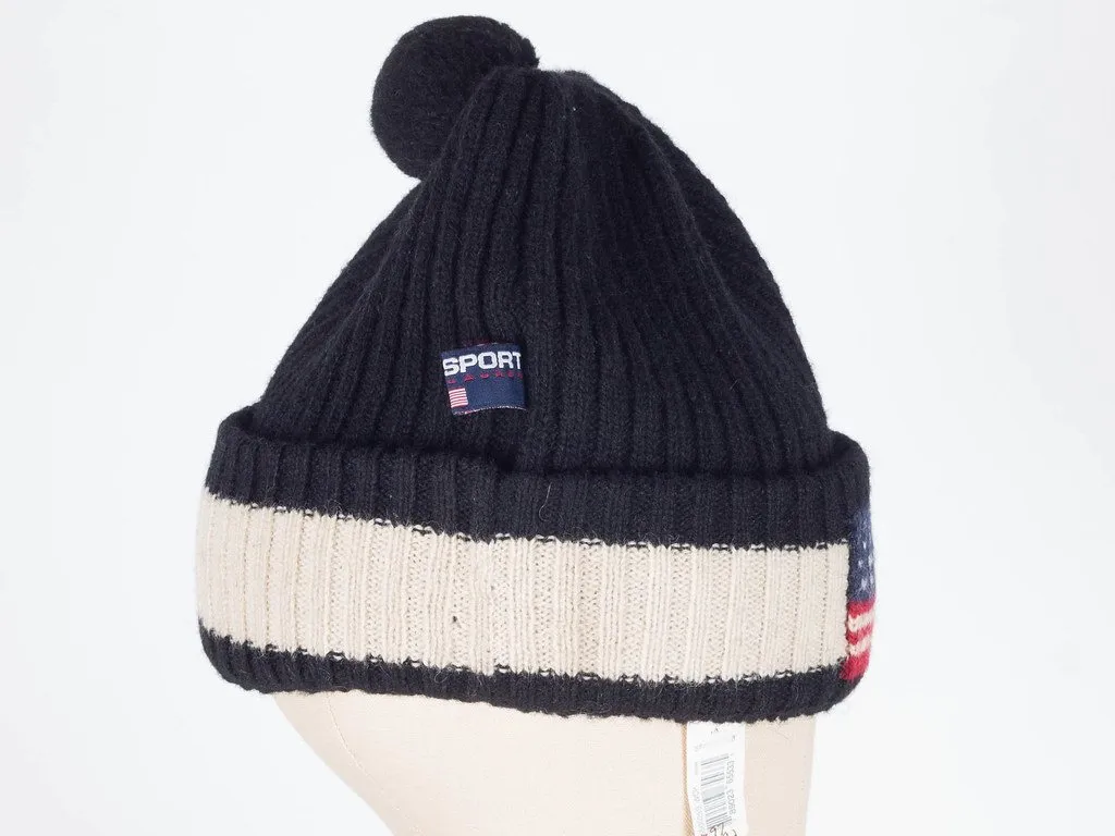 A navy and cream ribbed knit beanie with a pom-pom