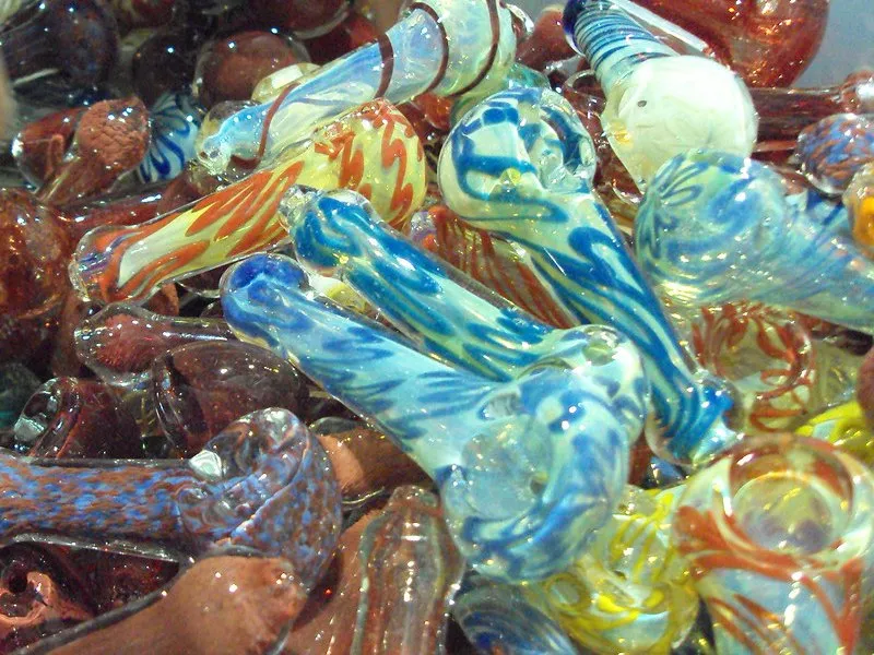 A pile of colorful hand-blown glass hand pipes